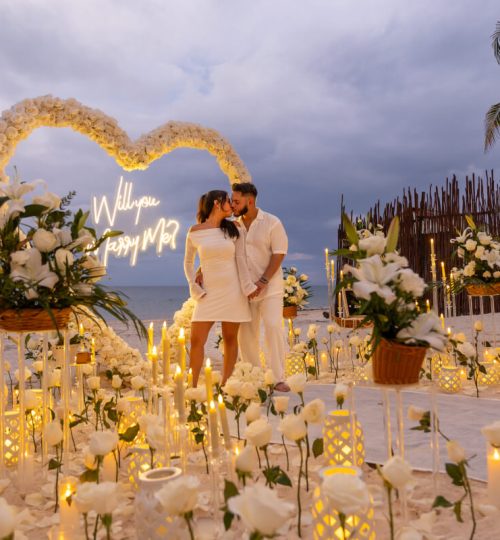 Romantic candlelight proposal with floral heart decoration