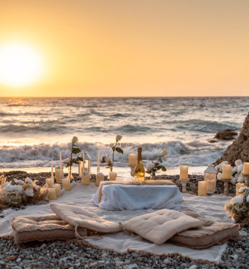 Luxury beach proposal setup at sunset with romantic decor