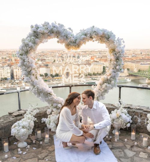 Luxury marriage proposal with heart arch overlooking city view